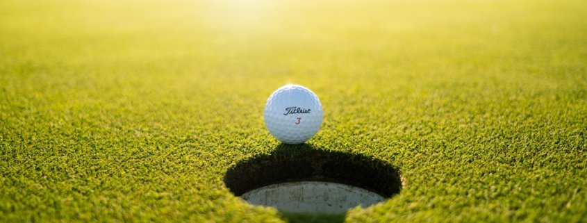 golf ball on green grass field during daytime